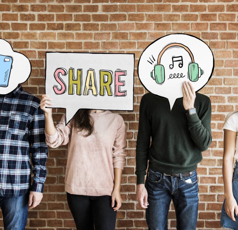 Friends holding up thought bubbles with social media concept icons